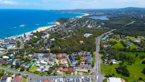 an aerial view of a town next to the ocean at The Quarters, Ascend Hotel Collection in Wamberal