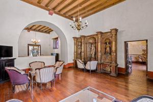 a dining area with a table and chairs in a room at Quinta Real Puebla in Puebla