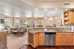 a kitchen with a large counter top and a living room at Apres Ski Chalet in Leavenworth