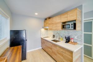 a kitchen with wooden cabinets and a black refrigerator at Lakeport Studio Near Boat Launch Pier Access! in Lakeport +24 photos