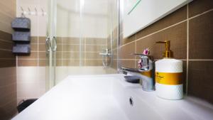 a bathroom sink with a soap dispenser on it at Sea view apartement in Durrës +9 photos