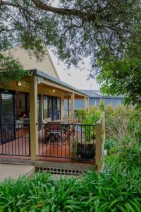 a house with a gate and a table on a porch at Tyrone Sands Rye in Rye