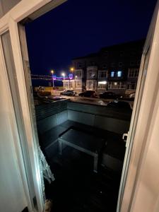 a view of a balcony at night from a window at RESIDENCY LUXURY SEAFRONT HOTEL in Blackpool