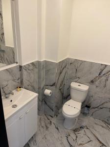 a bathroom with a white toilet and a sink at RESIDENCY LUXURY SEAFRONT HOTEL in Blackpool