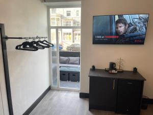 a room with a flat screen tv on the wall at RESIDENCY LUXURY SEAFRONT HOTEL in Blackpool