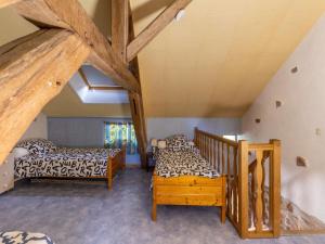 A bed or beds in a room at Stone country house in Rouy with private pool