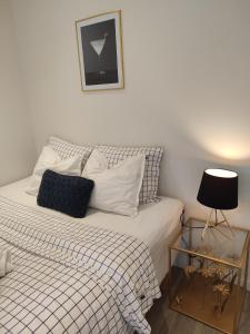 a bed with a black and white comforter and a side table at Göteborgs Pärla in Gothenburg