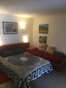 a bedroom with a bed and a couch at Les Arches du Cloître in Corneilla-de-Conflent