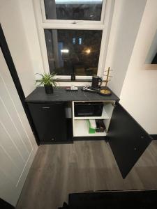 a small kitchen with a sink and a window at RESIDENCY LUXURY SEAFRONT HOTEL in Blackpool