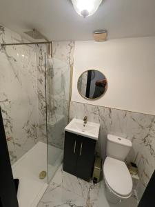 a bathroom with a toilet and a shower and a sink at RESIDENCY LUXURY SEAFRONT HOTEL in Blackpool