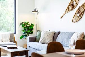 a living room with a couch and a table at Revy's Stellar Retreat in Revelstoke