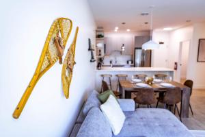 a living room with a couch and a dining room at Revy's Stellar Retreat in Revelstoke