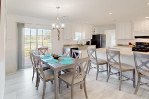 una cucina e una sala da pranzo con tavolo e sedie di Long Lake House a Okeechobee