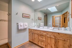 een badkamer met 2 wastafels en een grote spiegel bij Titleist 4 in Sunriver