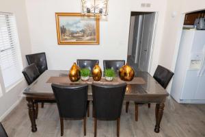a dining room table with black chairs and a wooden table at HERITAGE HOUSE GREAT FOR GROUPS!!! in Pahrump
