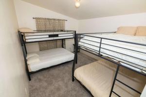 two bunk beds in a small room with a mattress at HERITAGE HOUSE GREAT FOR GROUPS!!! in Pahrump