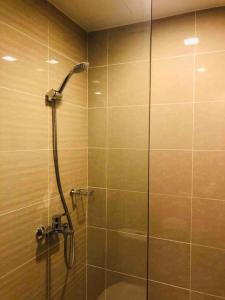 a shower with a glass door in a bathroom at Great Value in Uptown Parksuites BGC 1BR,Washer,Netflix in Manila