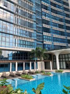 a large building with a swimming pool in front of a building at Great Value in Uptown Parksuites BGC 1BR,Washer,Netflix in Manila