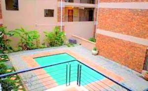 a swimming pool on a balcony of a building at Kempton Park Self Catering Private House Nearby to OR Tambo International Airport in Boksburg