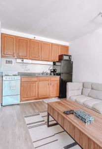 a kitchen with a couch and a table in a room at Modern Studio - Heart of Waikiki with Parking! in Honolulu
