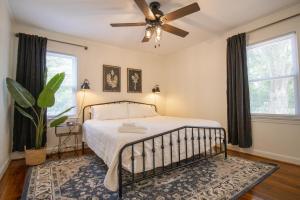 a bedroom with a bed and a ceiling fan at Industrial Chic Getaway Simpsonville - Family Home in Simpsonville