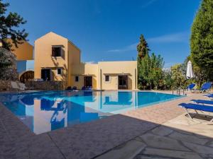a villa with a swimming pool in front of a house at 2 houses and 2 studios -small group in Douliana