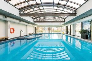 a pool with two swimming pools with a ceiling at HeartCBD LUX Top Floor 2 Bedroom /Pool/Spa/GYM in Melbourne