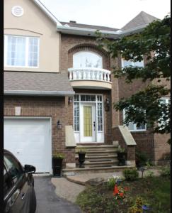una casa con una porta bianca e un garage bianco di Leila`s place-Basement apartment in private home a Gatineau