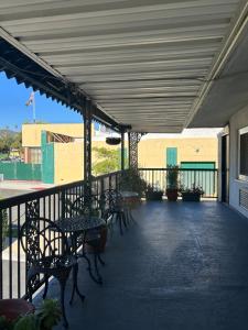 eine Terrasse mit Tischen und Stühlen auf einem Gebäude in der Unterkunft Welcome Inn in Los Angeles