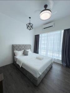 a bedroom with a large bed and a large window at SDC Suite Home in Lahad Datu