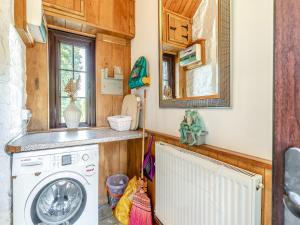 a kitchen with a washing machine in a tiny house at The Chapel - Uk45104 in Hoel-galed