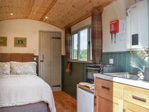 a small kitchen with a bed and a sink at Partridge Hut-uk44850 in Walton