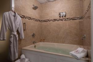 a bathroom with a bath tub and a sink at Carlisle House Bed and Breakfast in Carlisle