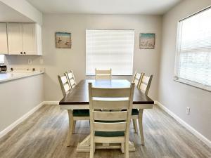 a kitchen and dining room with a table and chairs at Sandy Beach Sunset West in Clearwater Beach