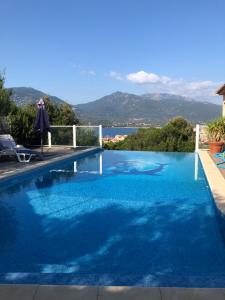 a swimming pool with a view of the water at punta di buturetu in Propriano