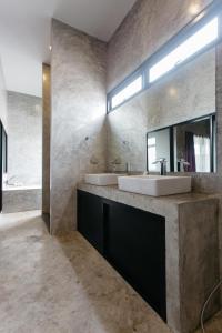 a bathroom with two sinks and a mirror at Arun Rawee อรุณ รวี in Chiang Mai