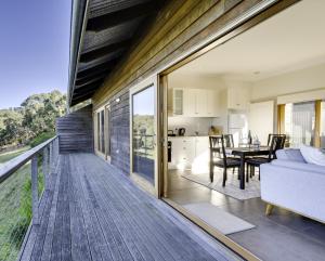 an open deck with a living room and dining room at Seascape Retreat in Victor Harbor