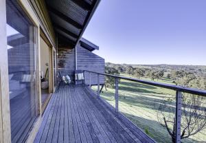 a balcony of a house with a view of a field at Seascape Retreat in Victor Harbor