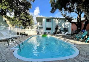 a swimming pool in front of a house at Sun, Sand, Coastal Haven 1 in Clearwater Beach