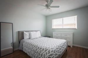 a bedroom with a bed and a ceiling fan at Sun, Sand, Coastal Haven 3 in Clearwater Beach
