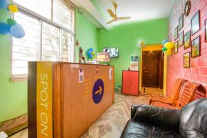 a room with a table and a couch in a room at OYO Petals Residency in Nager Bazaar