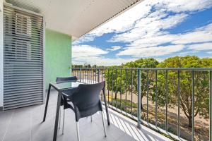 a balcony with a table and chairs on a balcony at Hudson Berrimah in Darwin