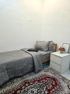 a bedroom with a bed and a rug at Soul Casa @Gurney Heights Keramat in Kuala Lumpur