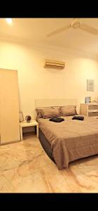 a bedroom with a large bed and a table at Soul Casa @Gurney Heights Keramat in Kuala Lumpur