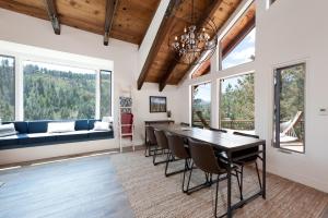 a dining room with a table and chairs and windows at 846 County Rd 207 in Durango
