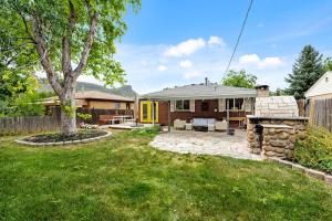 a backyard with a stone fireplace and a house at 204 High Pkwy - Golden in Golden