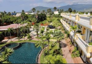 an aerial view of a resort with a pool and palm trees at Sokchea Kampot Hotel in Kampot