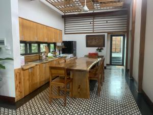 a kitchen with a large wooden table and chairs at KaoCat Sea Villa w/3BR 2BA AC 3km to DT & NightMK in Phú Quốc
