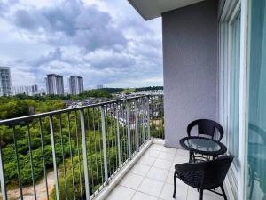 a balcony with two chairs and a view of a city at Spacious 6PX 3BR, Verdi @ Cyberjaya Near KLIA & KLIA2 in Cyberjaya