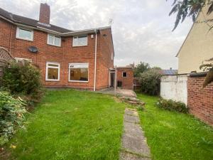 a brick house with a lawn in front of it at Cosy 3BR Home Close to Villa Park Castle Bromwich off the M6 in Birmingham